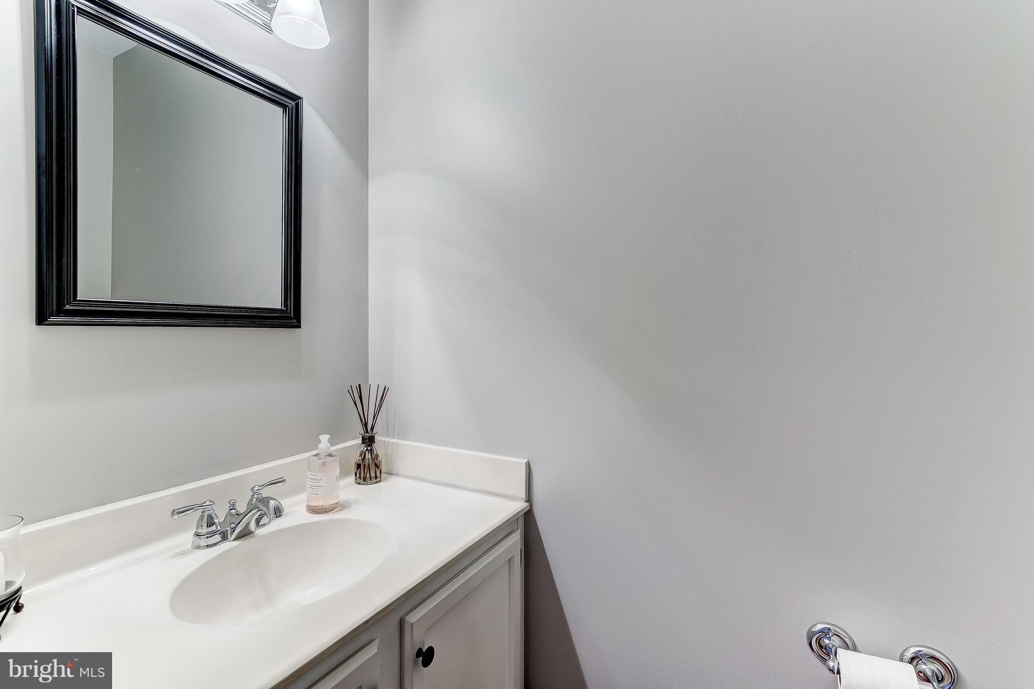 4313 Mispillion Road Baltimore, MD 21236 - Photo 18 of 38 a bathroom with a sink and a mirror