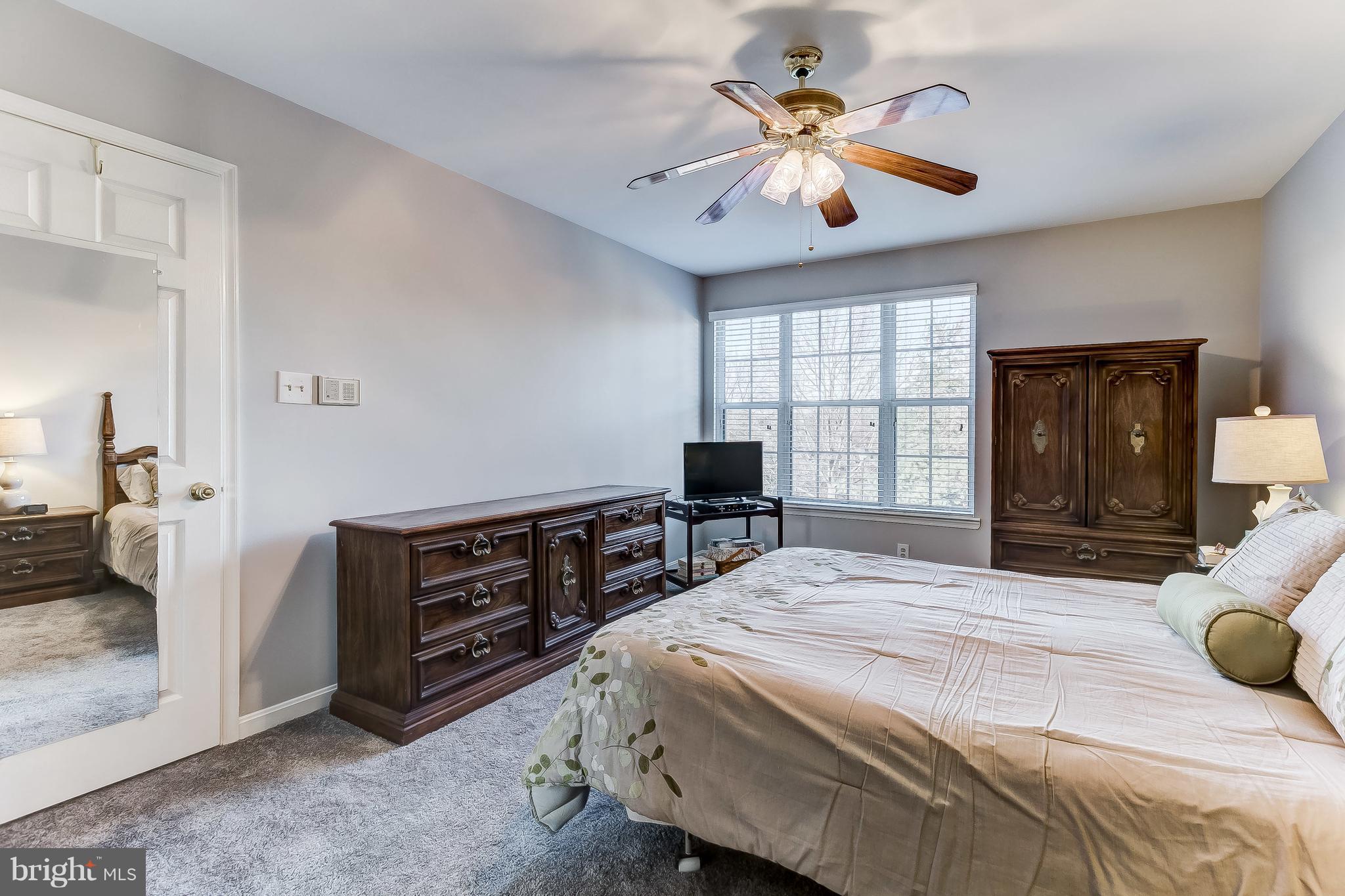 4313 Mispillion Road Baltimore, MD 21236 - Photo 20 of 38 a bedroom with a large bed and a chandelier