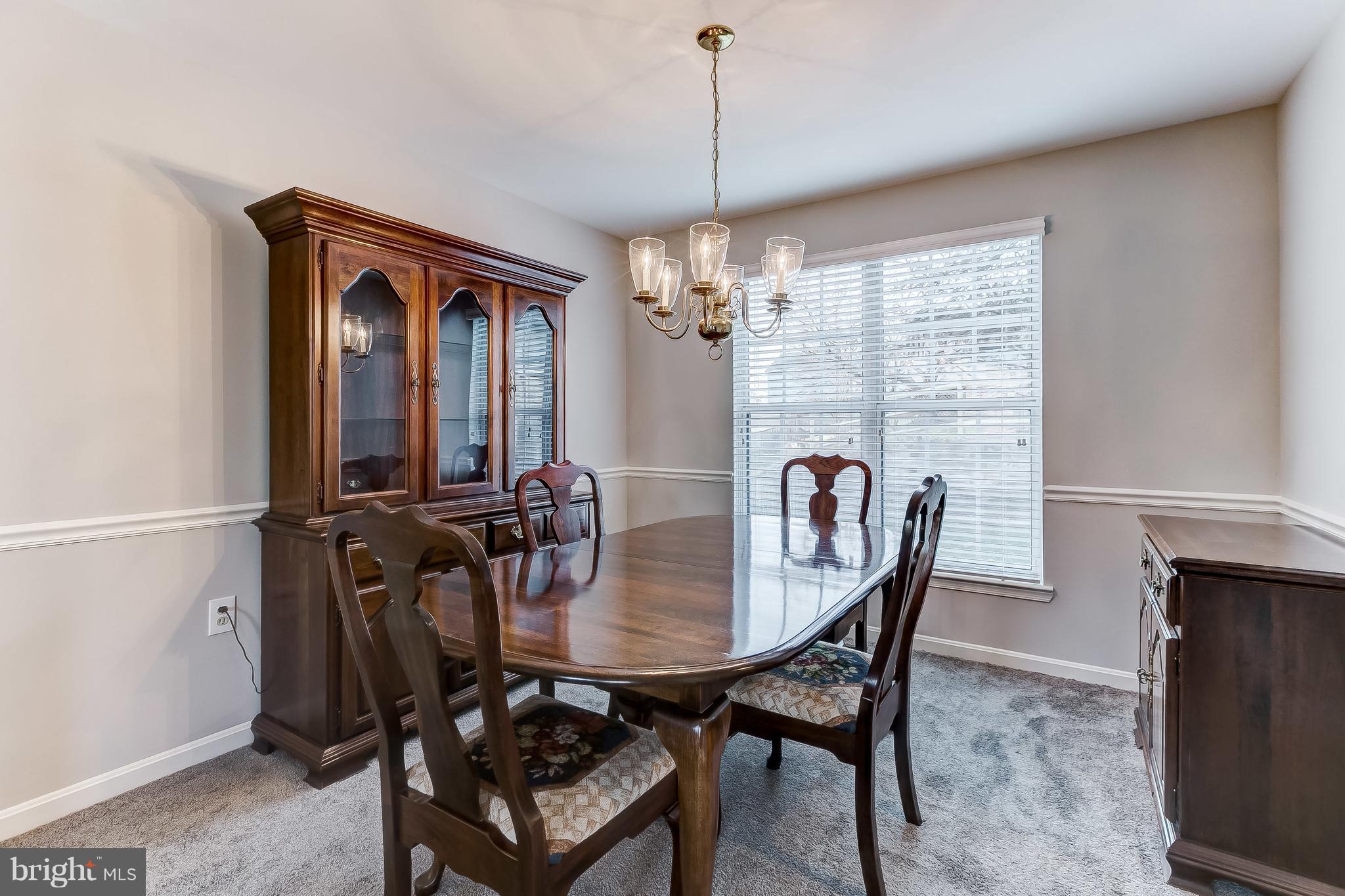 4313 Mispillion Road Baltimore, MD 21236 - Photo 7 of 38 a view of a dining room with furniture and chandelier