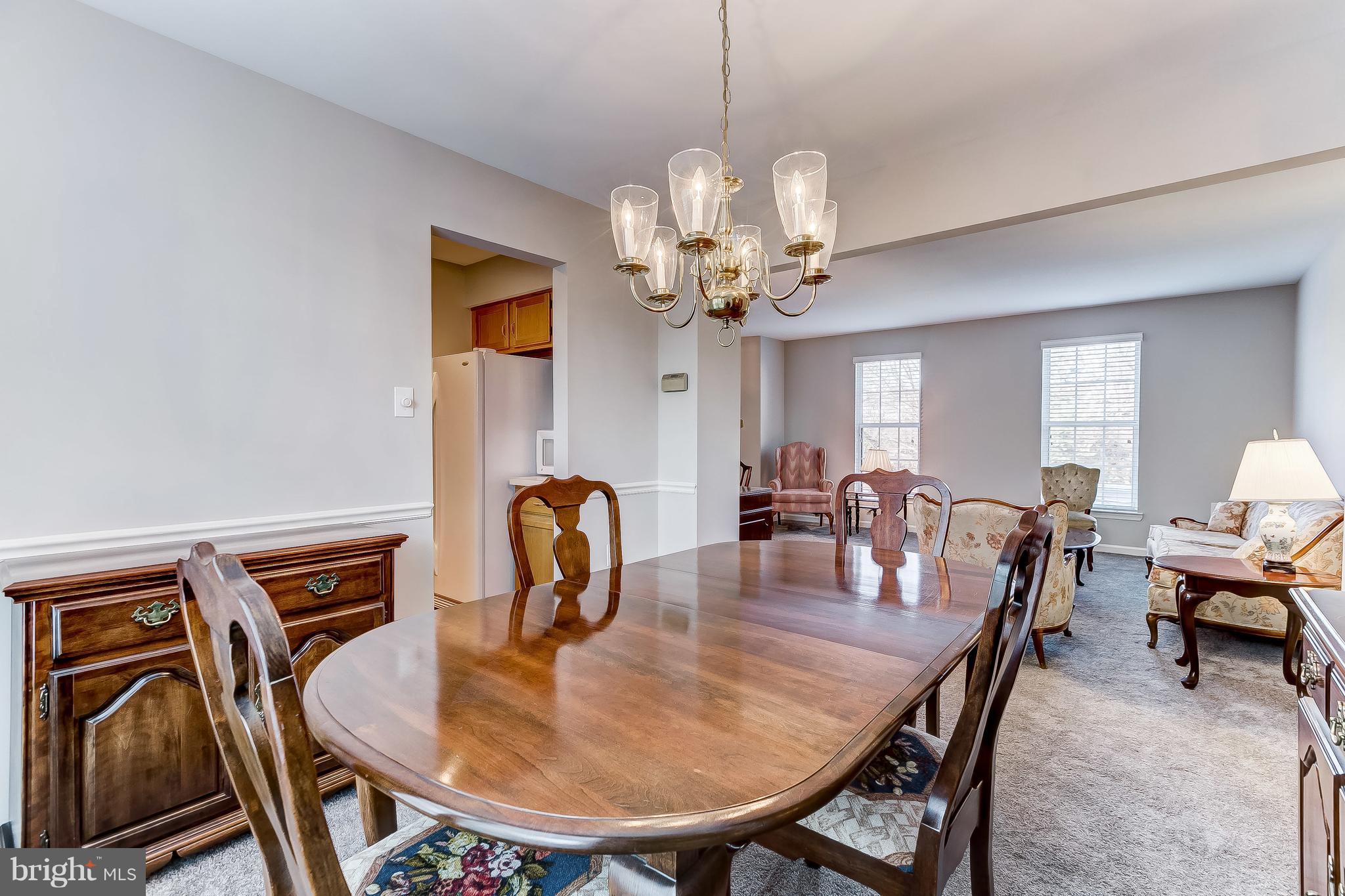 4313 Mispillion Road Baltimore, MD 21236 - Photo 9 of 38 a dining room with furniture a chandelier and wooden floor