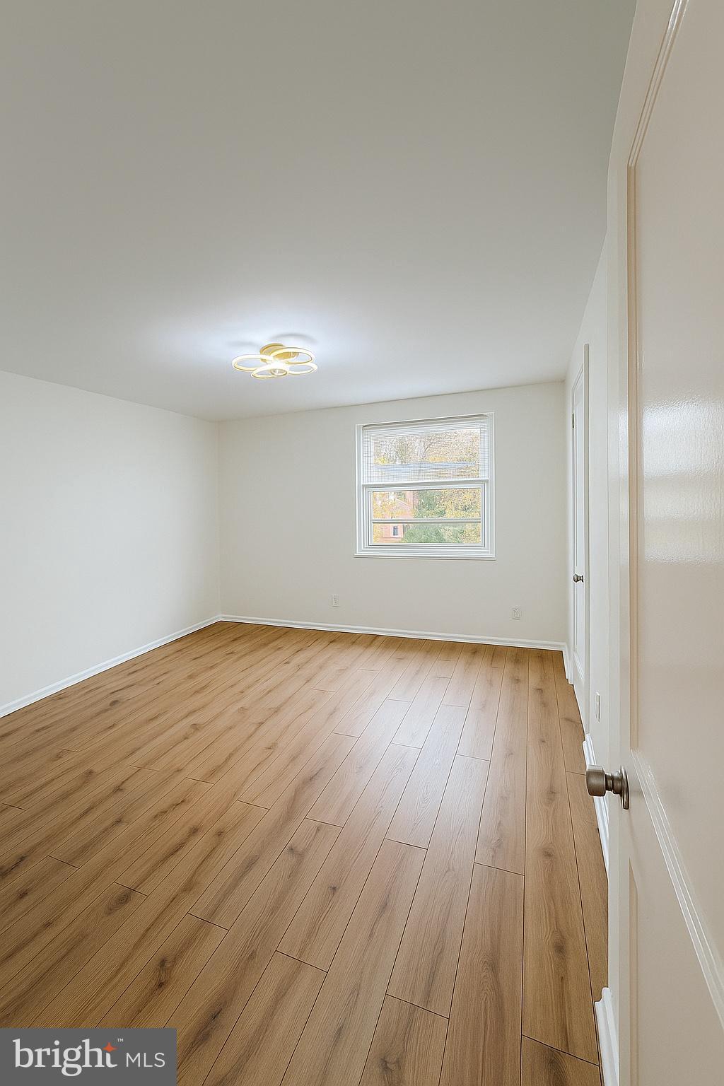 753 Bennington Road Folcroft, PA 19032 - Photo 11 of 25 an empty room with wooden floor and windows