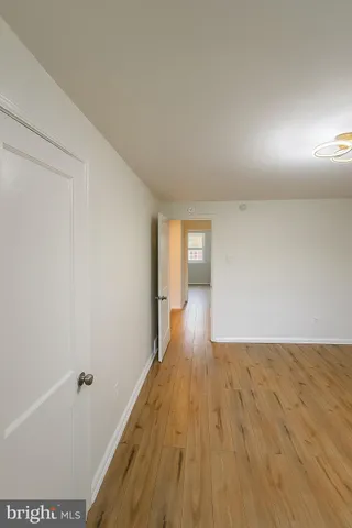 a view of hallway with wooden floor