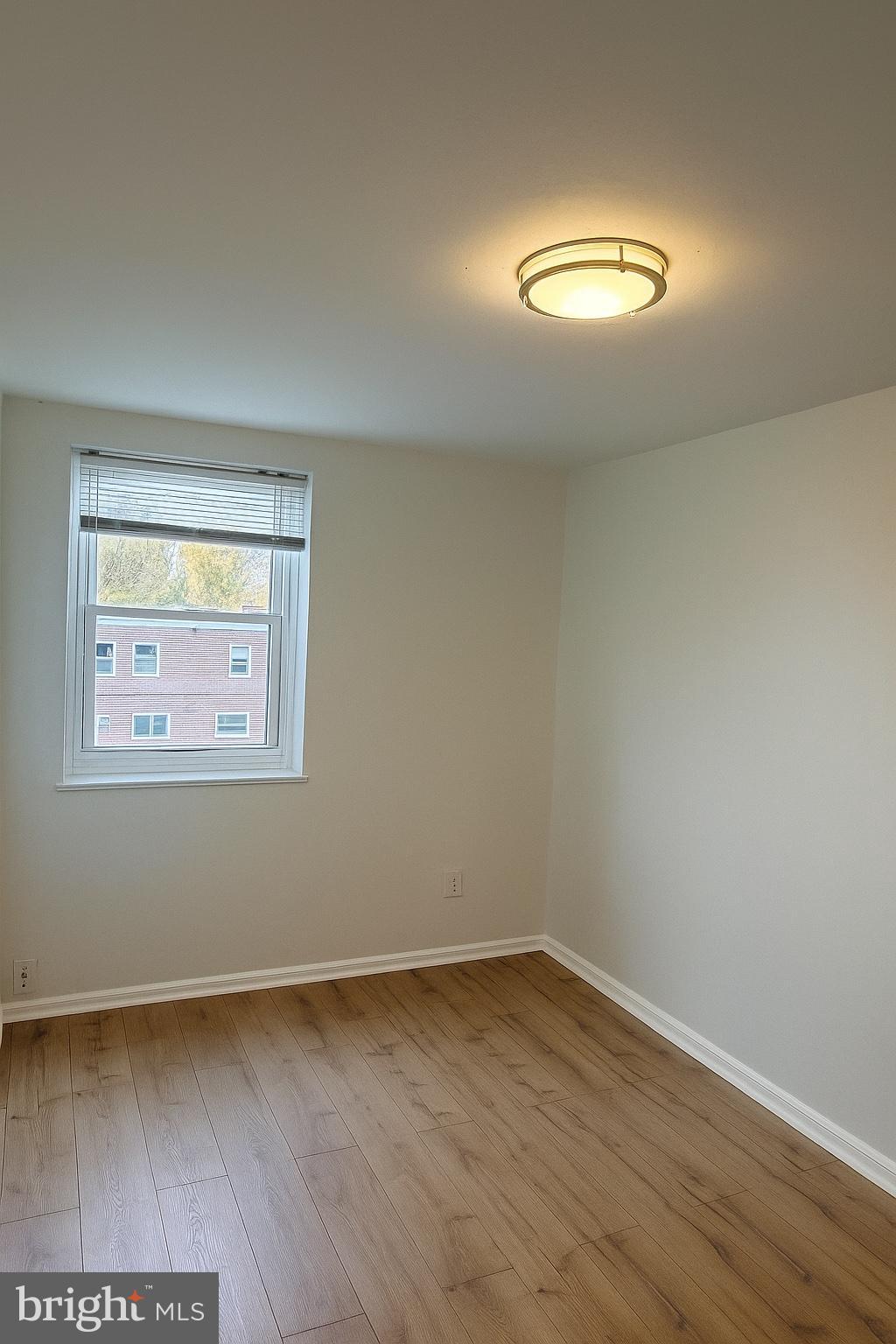 753 Bennington Road Folcroft, PA 19032 - Photo 14 of 25 a view of an empty room with wooden floor and a window