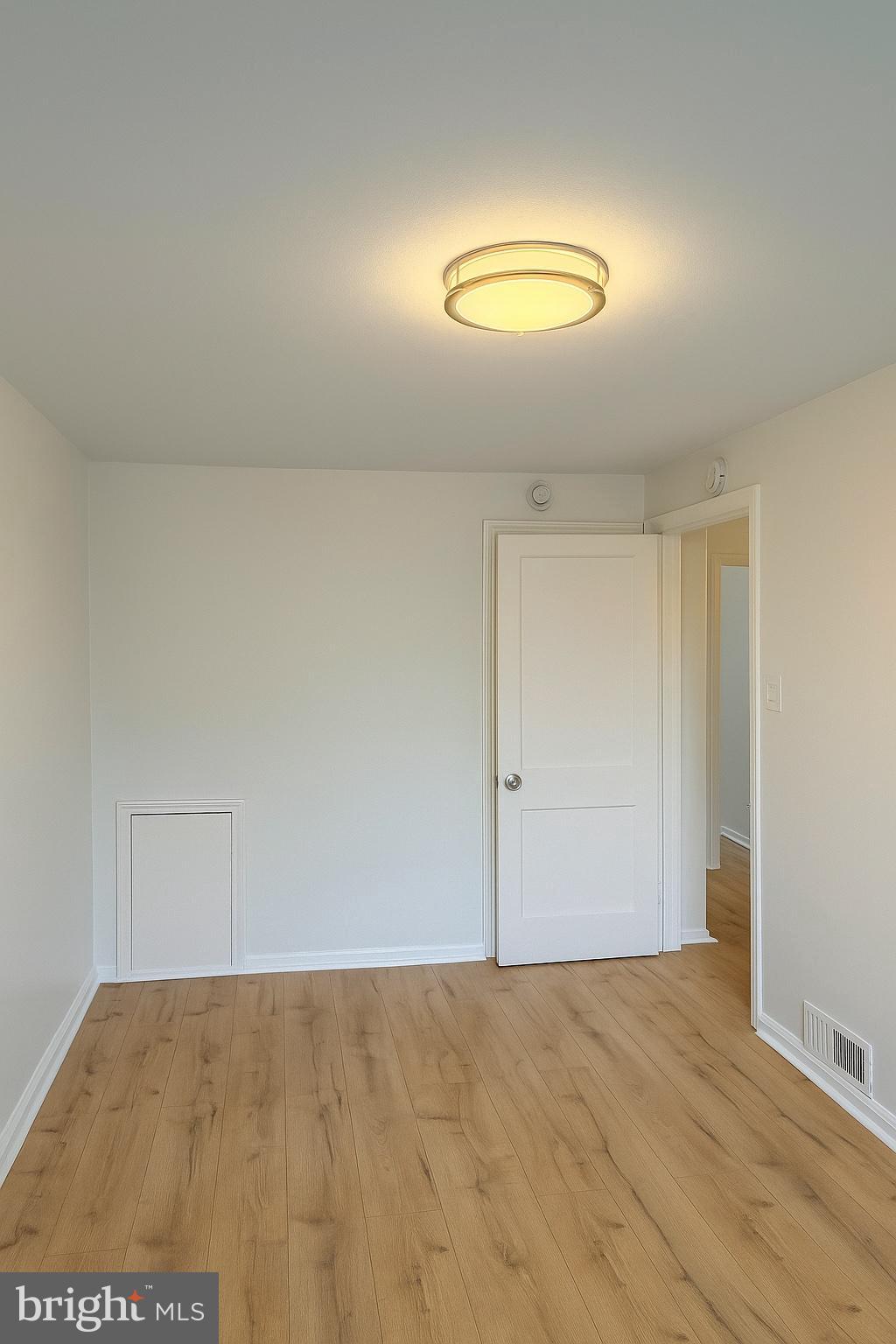 753 Bennington Road Folcroft, PA 19032 - Photo 17 of 25 an empty room with wooden floor and windows