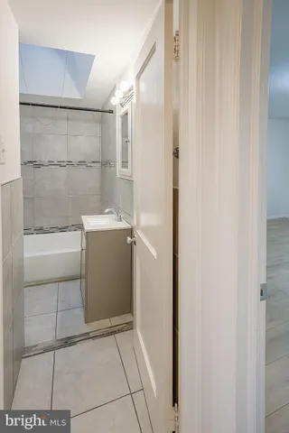 a bathroom with a shower and a sink