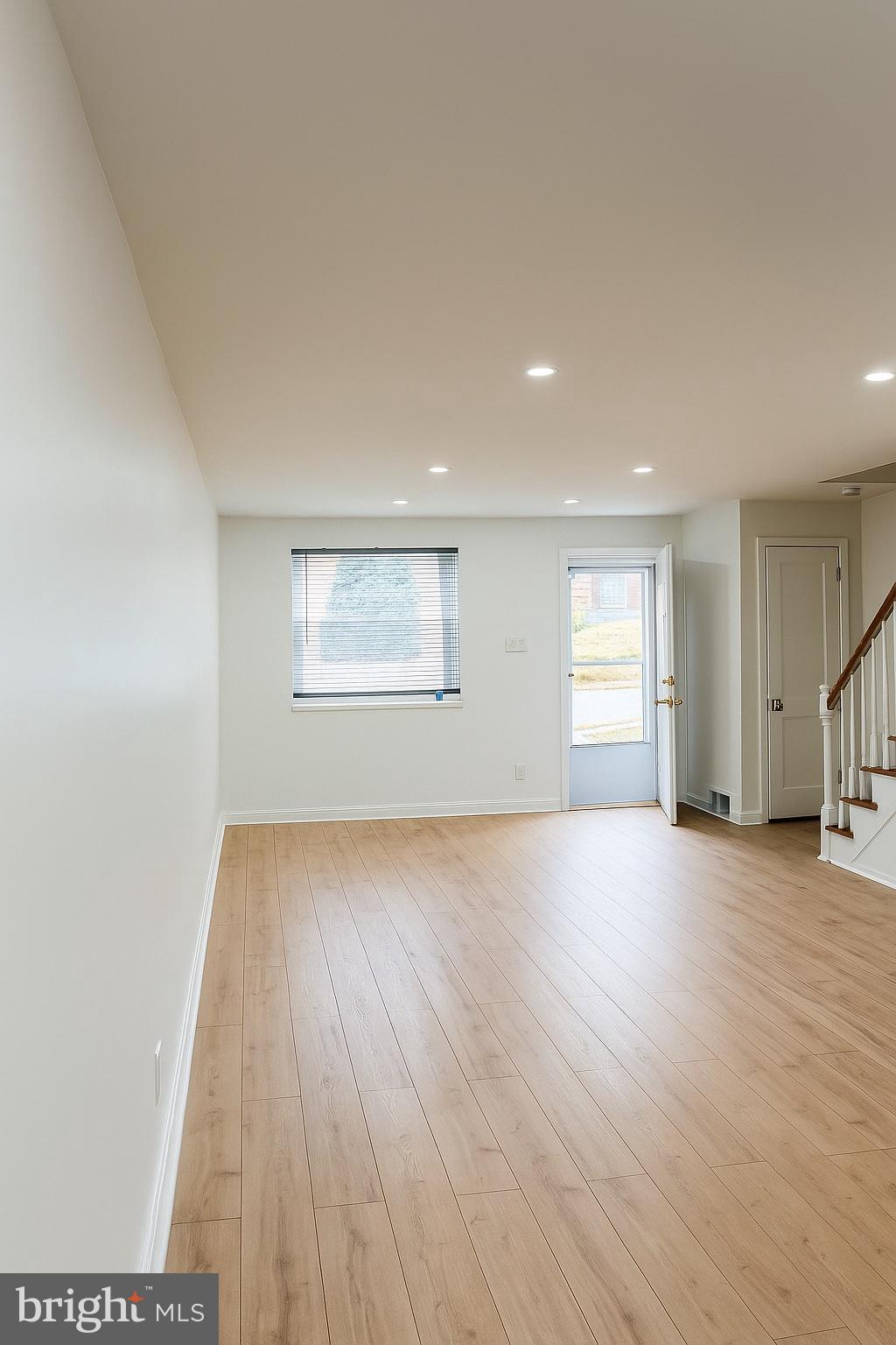 753 Bennington Road Folcroft, PA 19032 - Photo 4 of 25 an empty room with wooden floor and windows