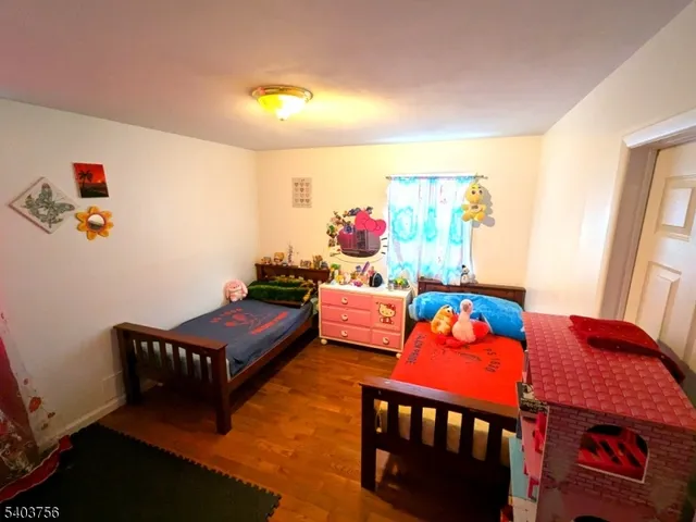 a bedroom with furniture and a wooden floor