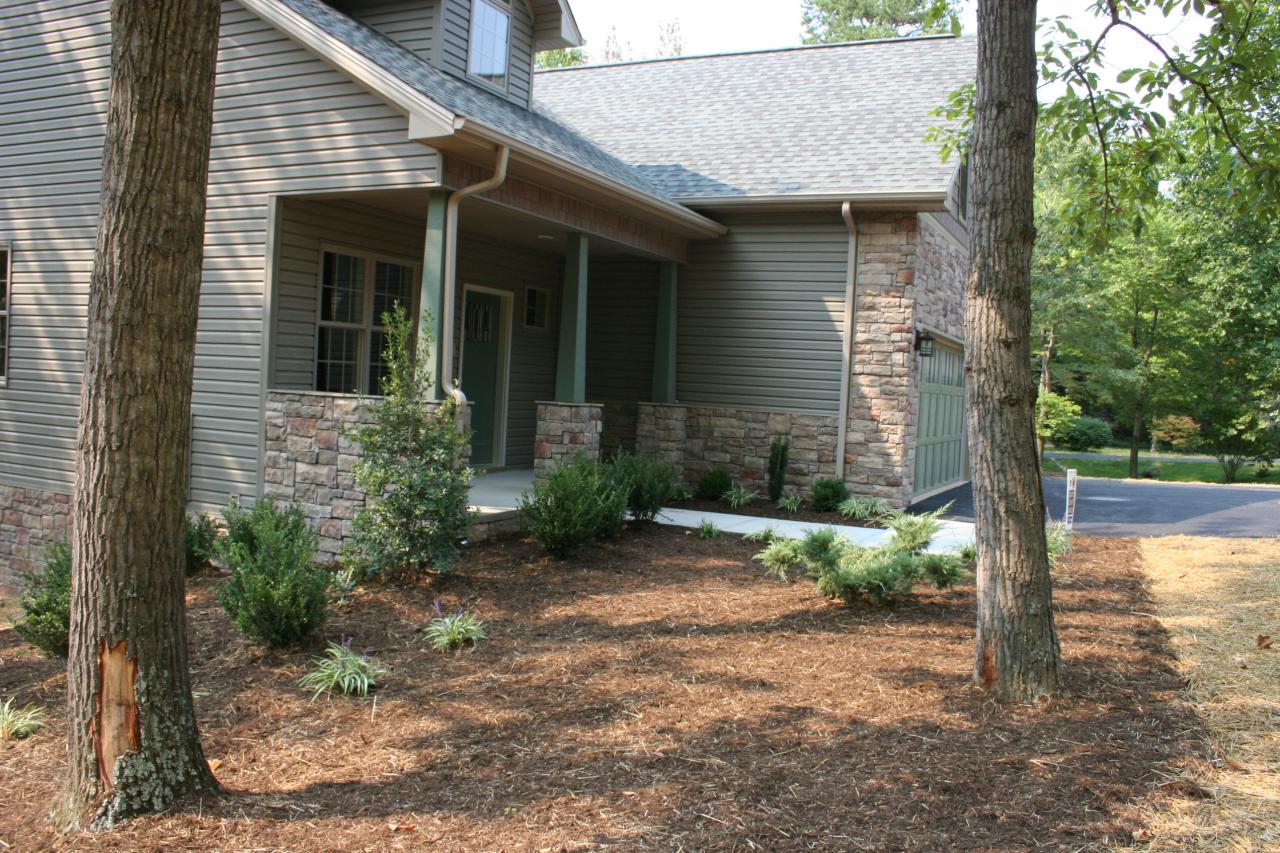91 Stonehaven Lane Blue Ridge, VA 24064 - Photo 51 of 52 a view of a small house with plants and large tree