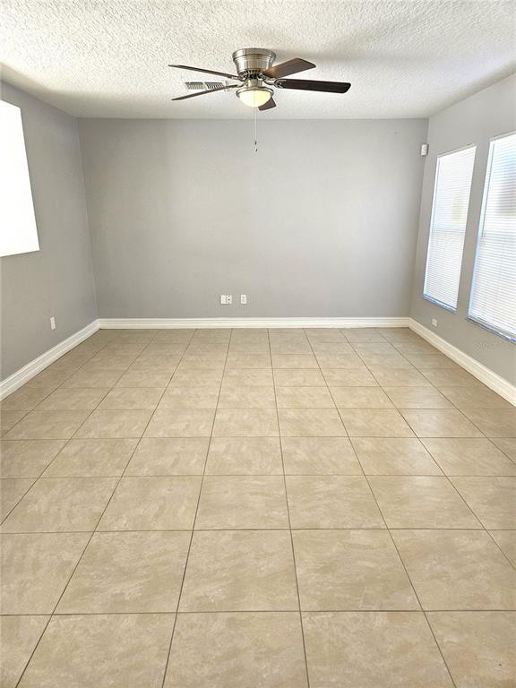 Undisclosed Address Orlando, FL 32818 - Photo 2 of 26 a view of a livingroom with an empty space and a window