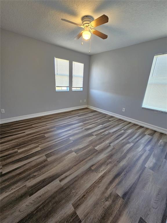 Undisclosed Address Orlando, FL 32818 - Photo 22 of 26 a view of an empty room with window and wooden floor