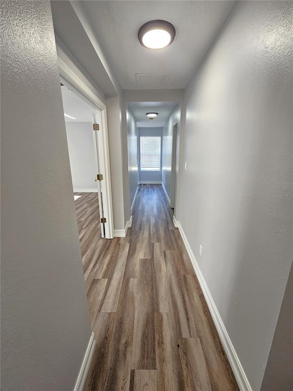 Undisclosed Address Orlando, FL 32818 - Photo 24 of 26 wooden floor in an empty room with a window