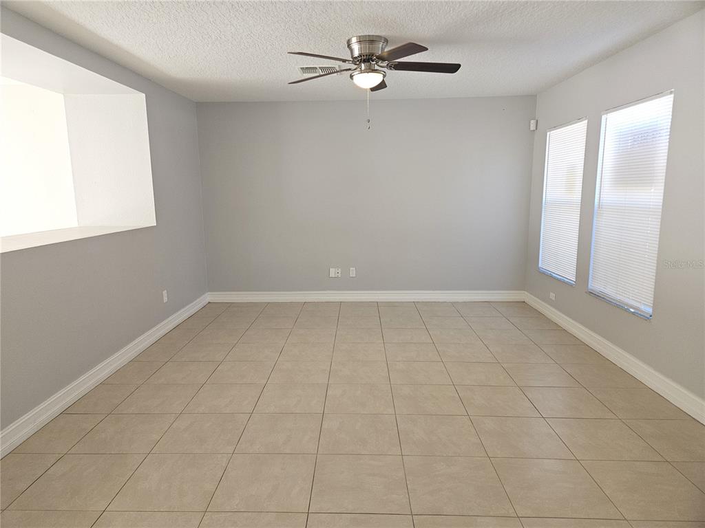 Undisclosed Address Orlando, FL 32818 - Photo 3 of 26 a view of an empty room with a window