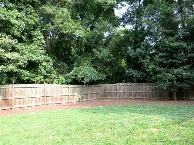 1627 Weatherford Circle Raleigh, NC 27604 - Photo 24 of 25 View of the fenced backyard which is surrounded by trees. The big .42 acre lot is nicely landscaped. Back Yard