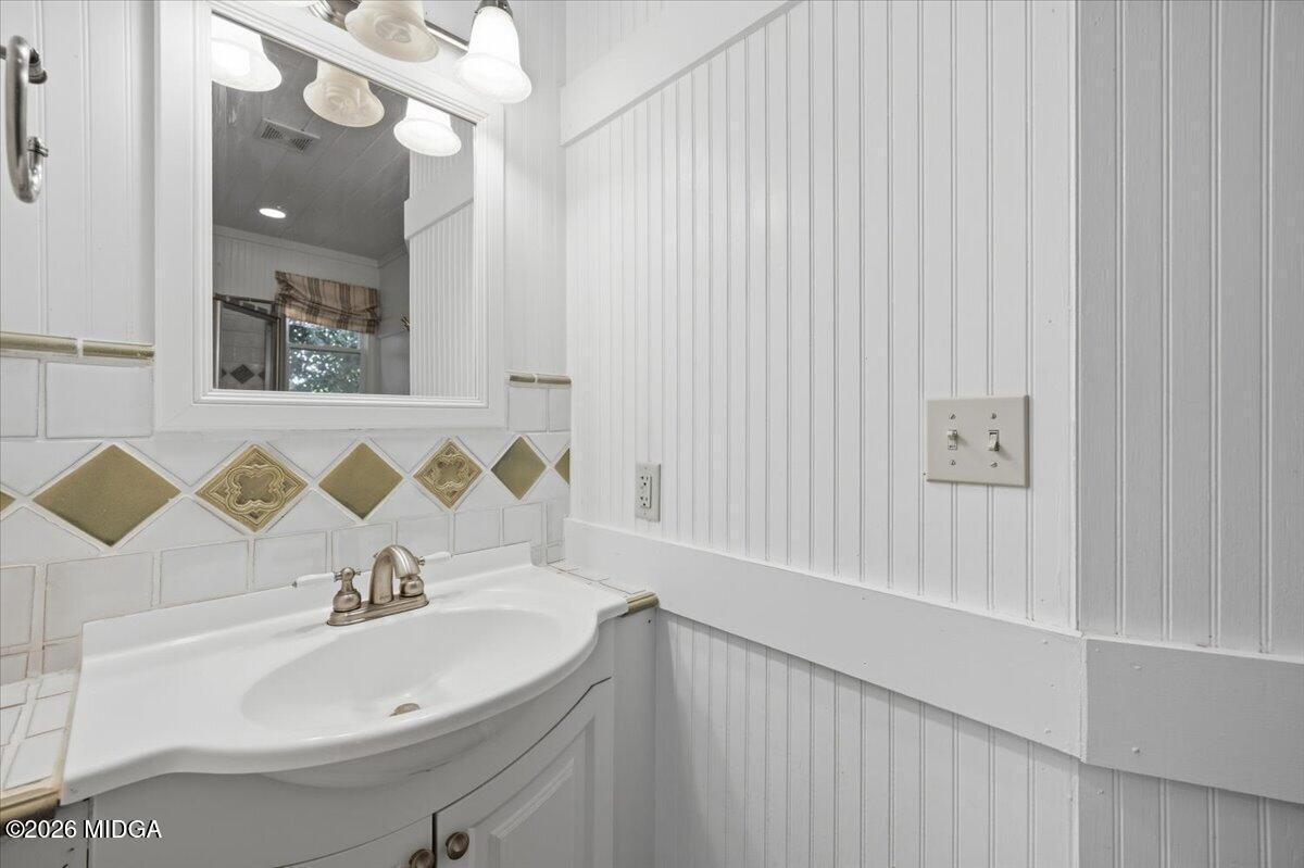 1019 Bond Street Macon, GA 31201 - Photo 11 of 56 a bathroom with a sink a mirror and a bathtub