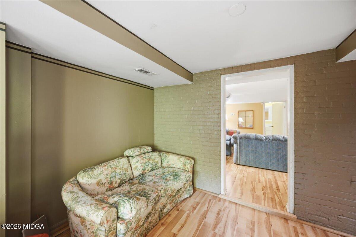 1019 Bond Street Macon, GA 31201 - Photo 27 of 56 a bedroom with a bed and wooden floor