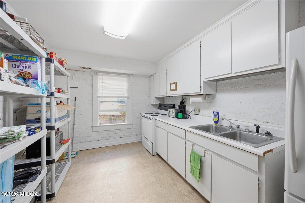 1019 Bond Street Macon, GA 31201 - Photo 29 of 56 a kitchen with refrigerator and cabinets