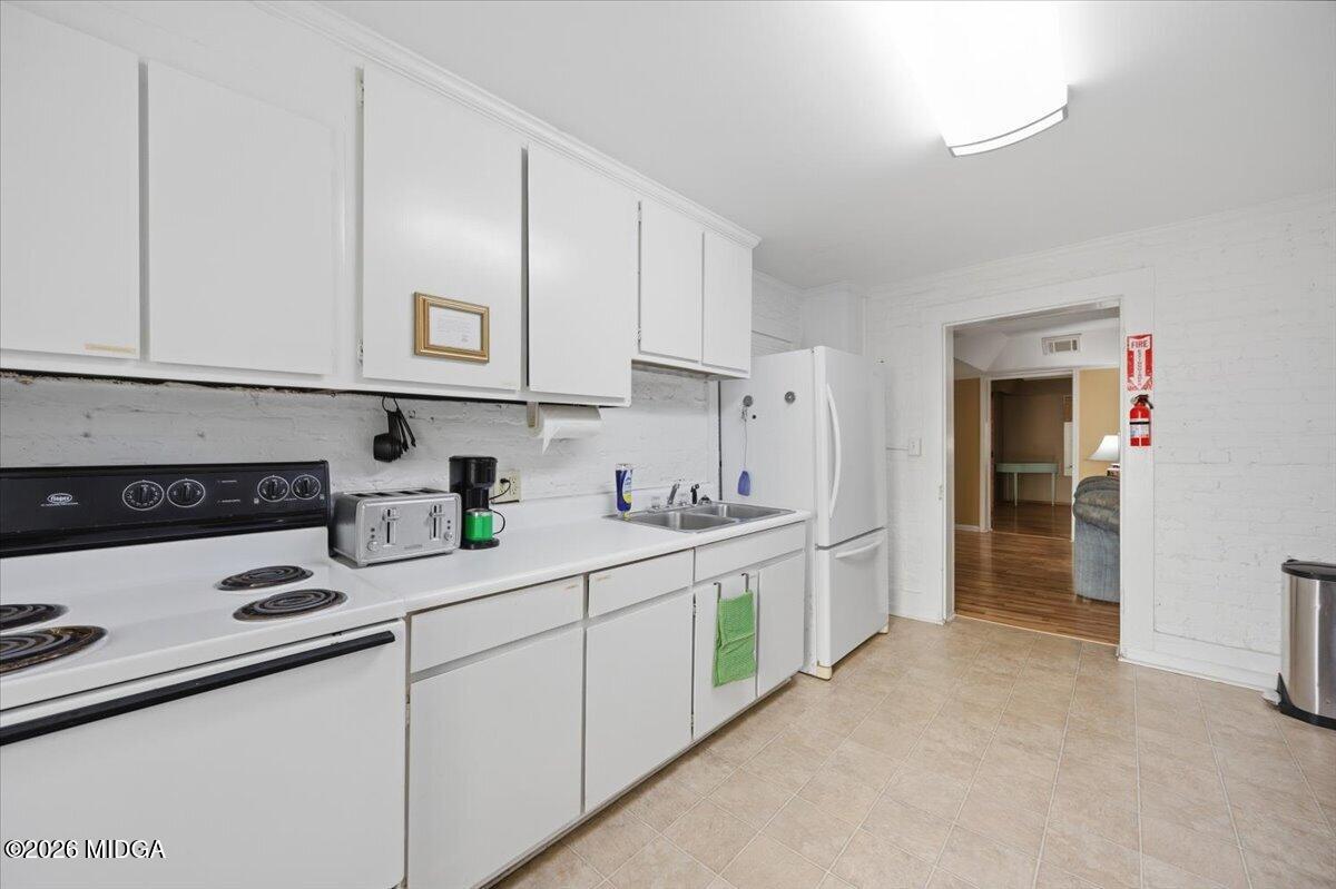 1019 Bond Street Macon, GA 31201 - Photo 30 of 56 a kitchen with stainless steel appliances granite countertop a sink and cabinets