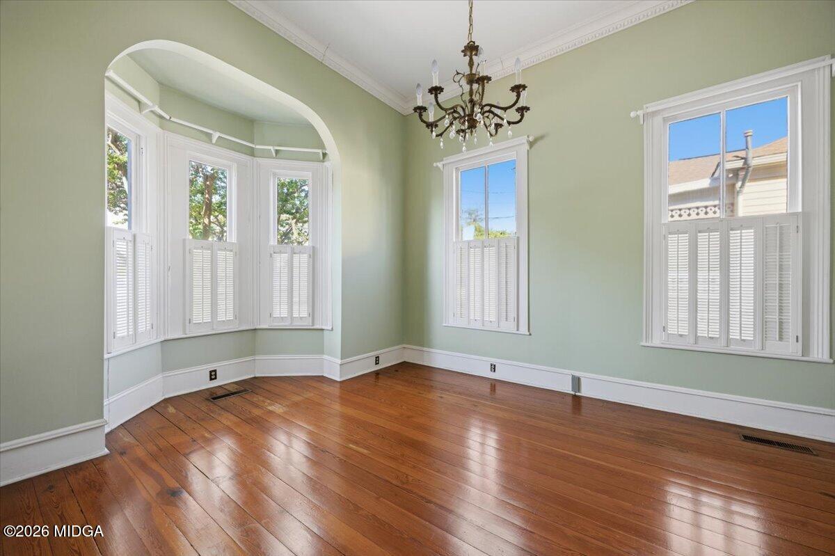 1019 Bond Street Macon, GA 31201 - Photo 3 of 56 a view of an empty room with wooden floor and a window