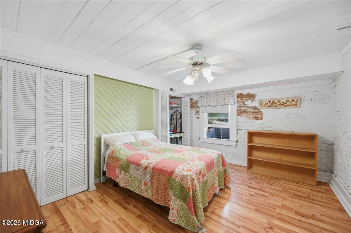 1019 Bond Street Macon, GA 31201 - Photo 31 of 56 a bedroom with a bed and a chandelier