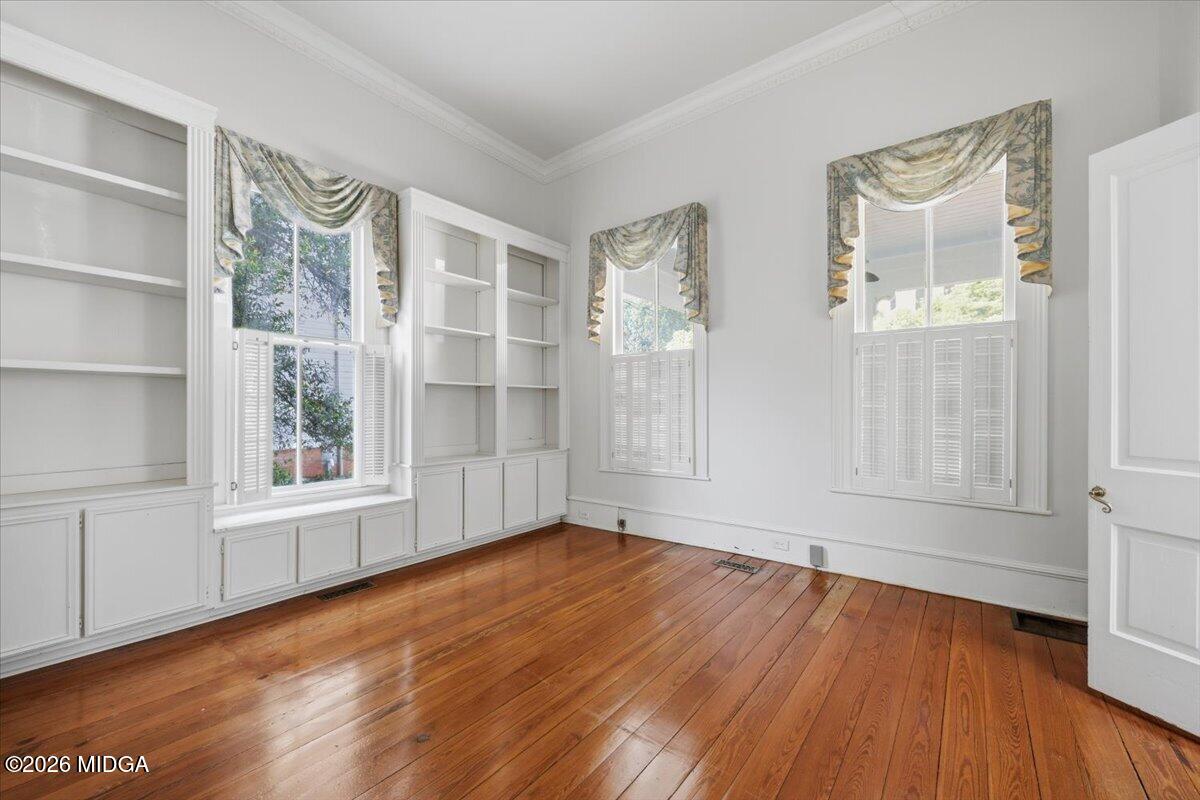1019 Bond Street Macon, GA 31201 - Photo 6 of 56 an empty room with wooden floor and windows