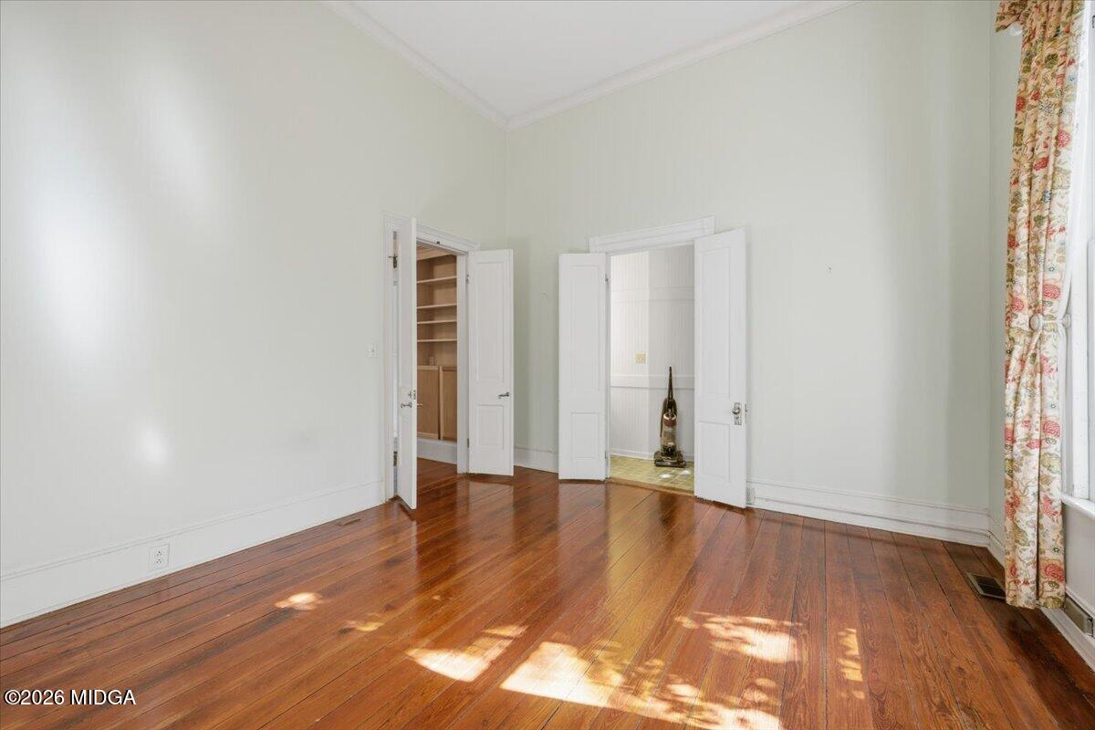 1019 Bond Street Macon, GA 31201 - Photo 10 of 56 a view of an empty room with wooden floor and a window