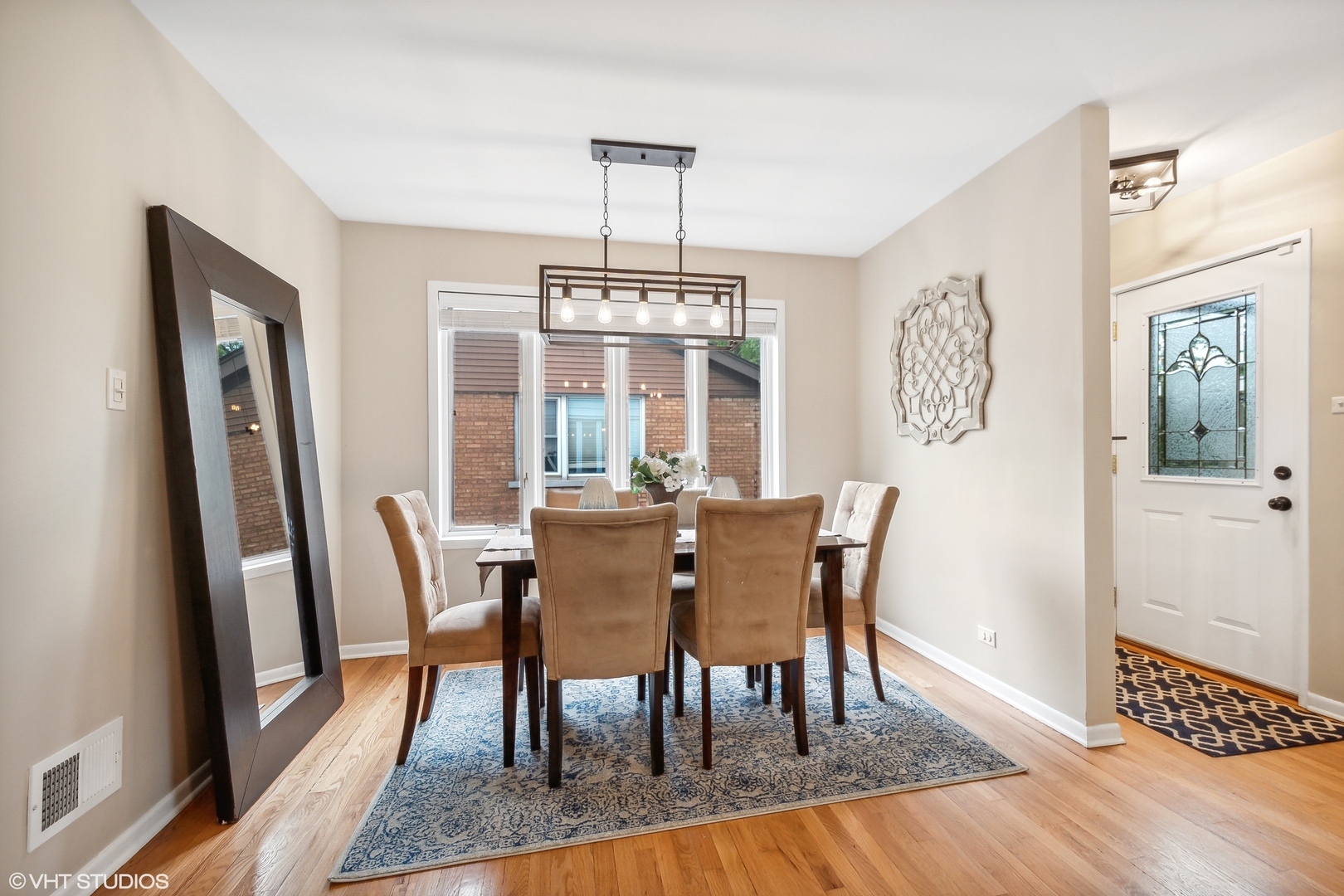 810 Shermer Road Glenview, IL 60025 - Photo 3 of 22 a dining room with furniture a chandelier and wooden floor