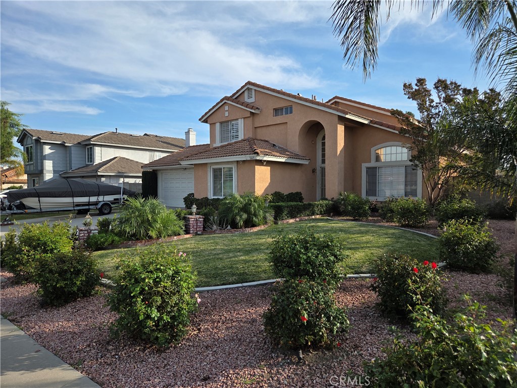 a front view of a house with a garden