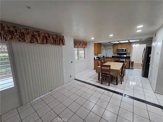 a bedroom with furniture and a large window