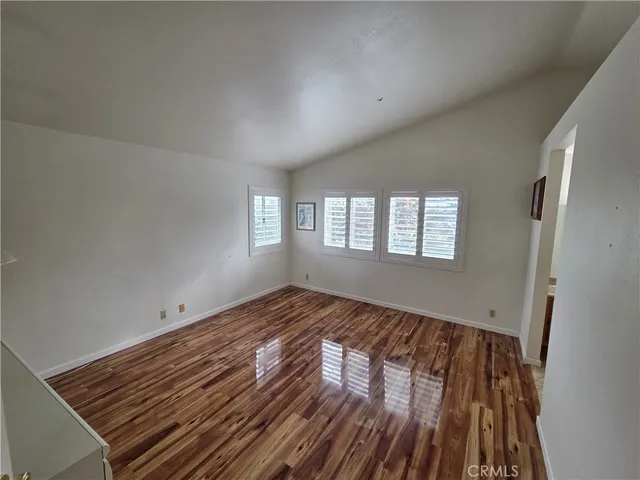 a view of wooden floor and windows in a room