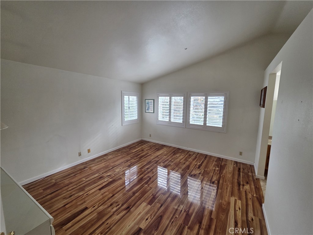 1669 West Victoria Street Rialto, CA 92376 - Photo 5 of 22 a view of wooden floor and windows in a room