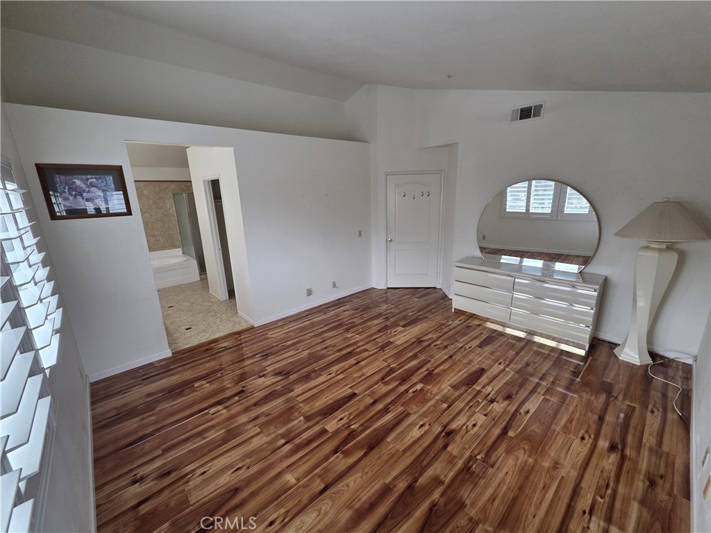 1669 West Victoria Street Rialto, CA 92376 - Photo 6 of 22 a bedroom with a bed and wooden floor