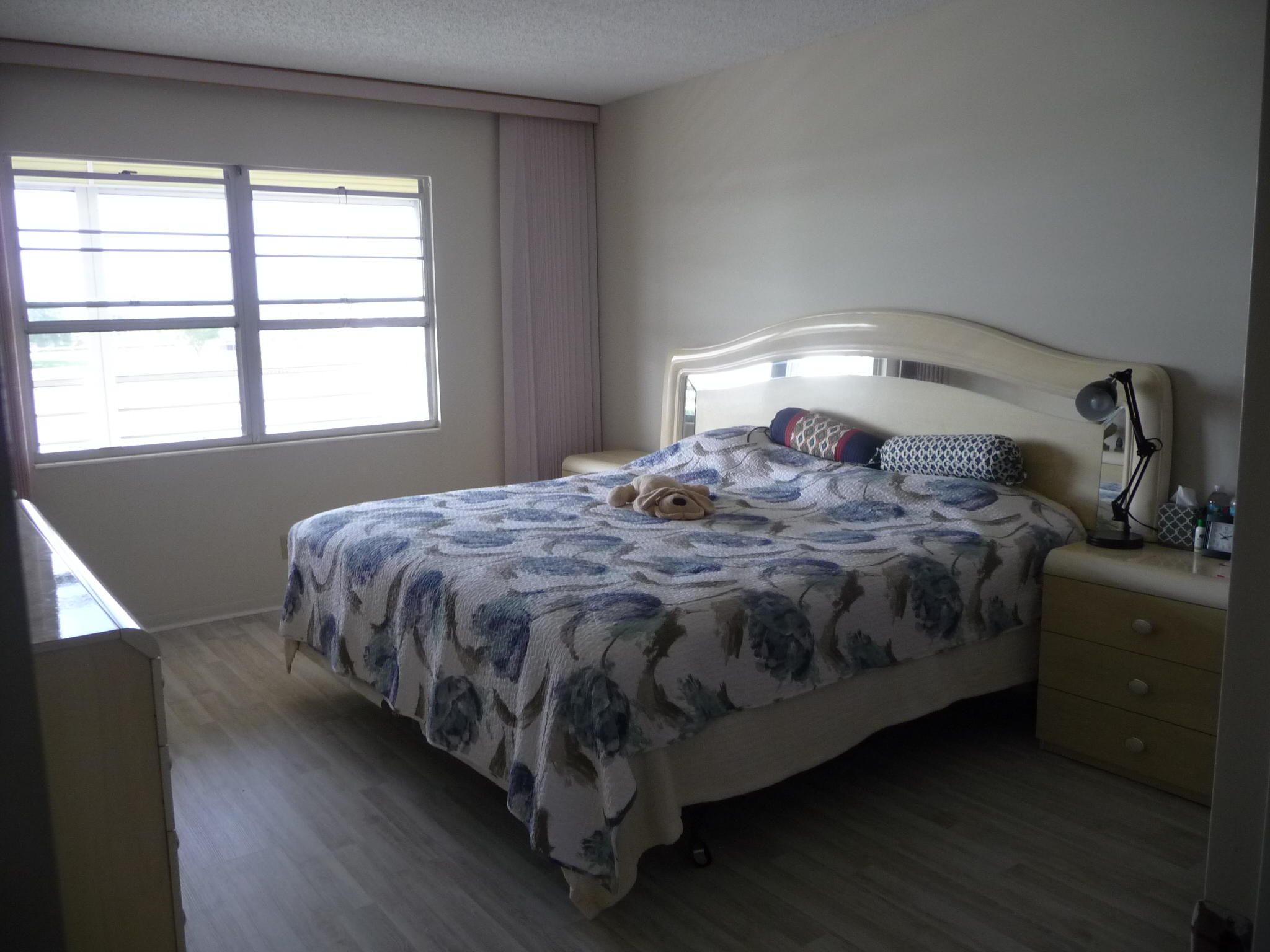 4057 Exeter Boca Raton, FL 33434 - Photo 6 of 10 a bedroom with a bed and a window