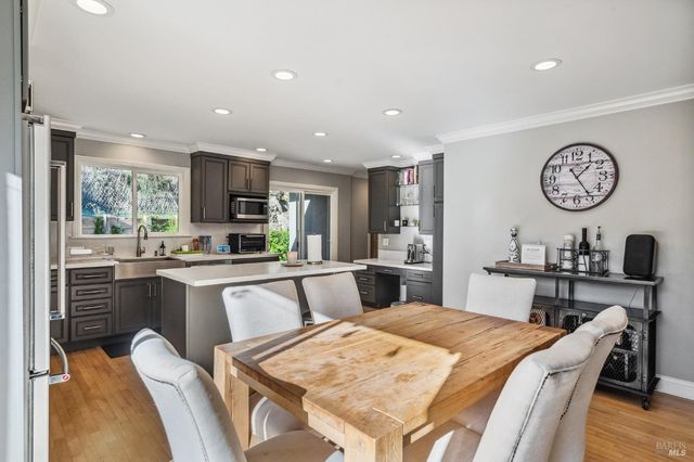 a large kitchen with a table and chairs