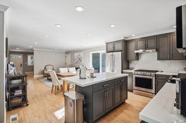 a kitchen with a sink stove and wooden cabinets