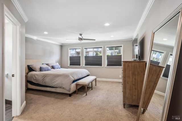 a spacious bedroom with a bed and glass door