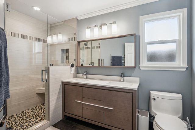 a bathroom with a toilet sink and mirror