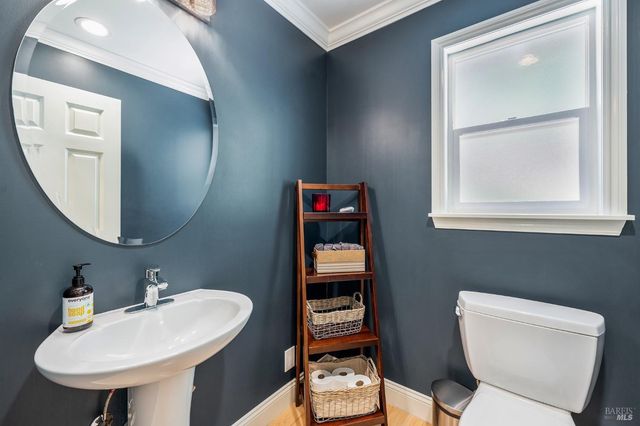 a bathroom with a toilet a sink and a mirror