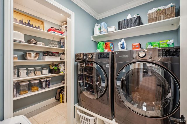 a view of entryway with washer and toys