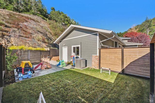 a view of a house with backyard porch and sitting area
