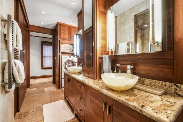 a bathroom with a granite countertop sink and a mirror