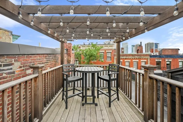 a view of a chairs and table in the balcony