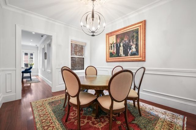 a view of a dining room with furniture wooden floor and a chandelier