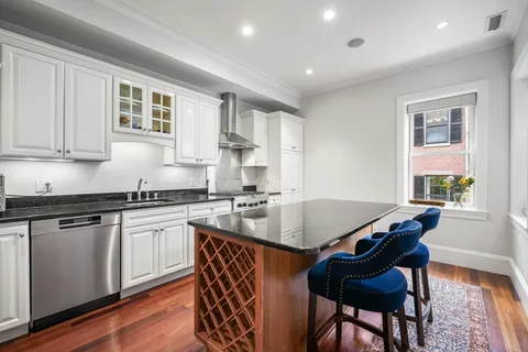 a kitchen with granite countertop lots of counter top space and stainless steel appliances