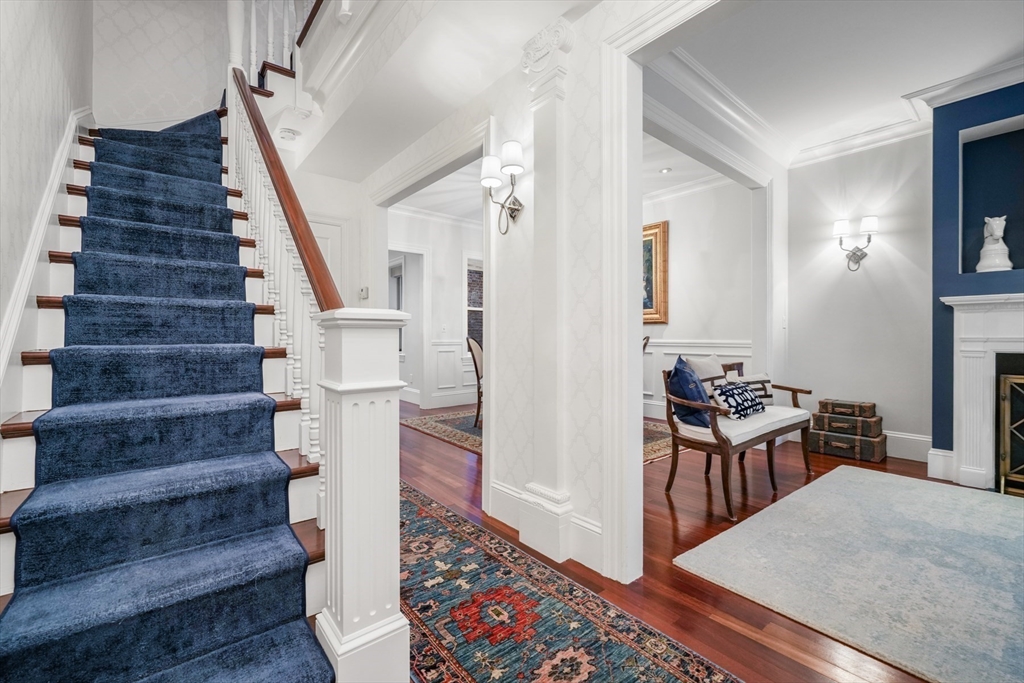 102 Myrtle Street Boston, MA 02114 - Photo 7 of 20 a view of a hallway with wooden floor and staircase