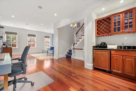 a livingroom with furniture a rug and wooden floor