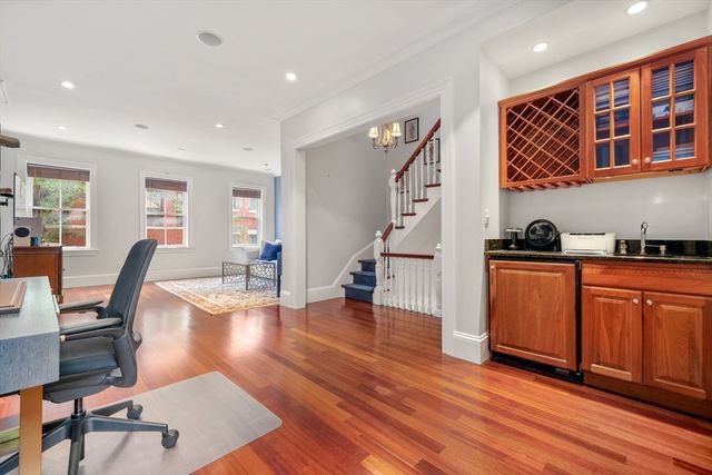 a livingroom with furniture a rug and wooden floor