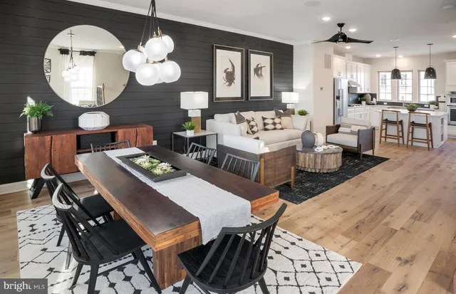a living room with couches a dining table and chairs with wooden floor