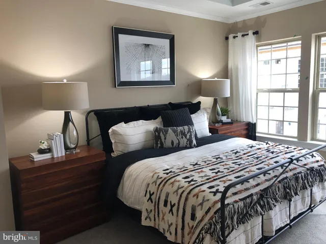 a bedroom with double bed and a window