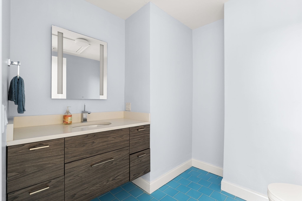 771 Harrison Avenue, Unit 206 Boston, MA 02118 - Photo 14 of 22 a bathroom with a sink and a mirror