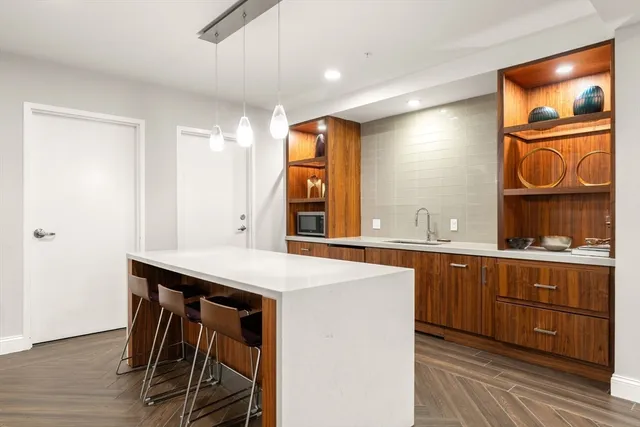 a kitchen with a sink cabinets and wooden floor